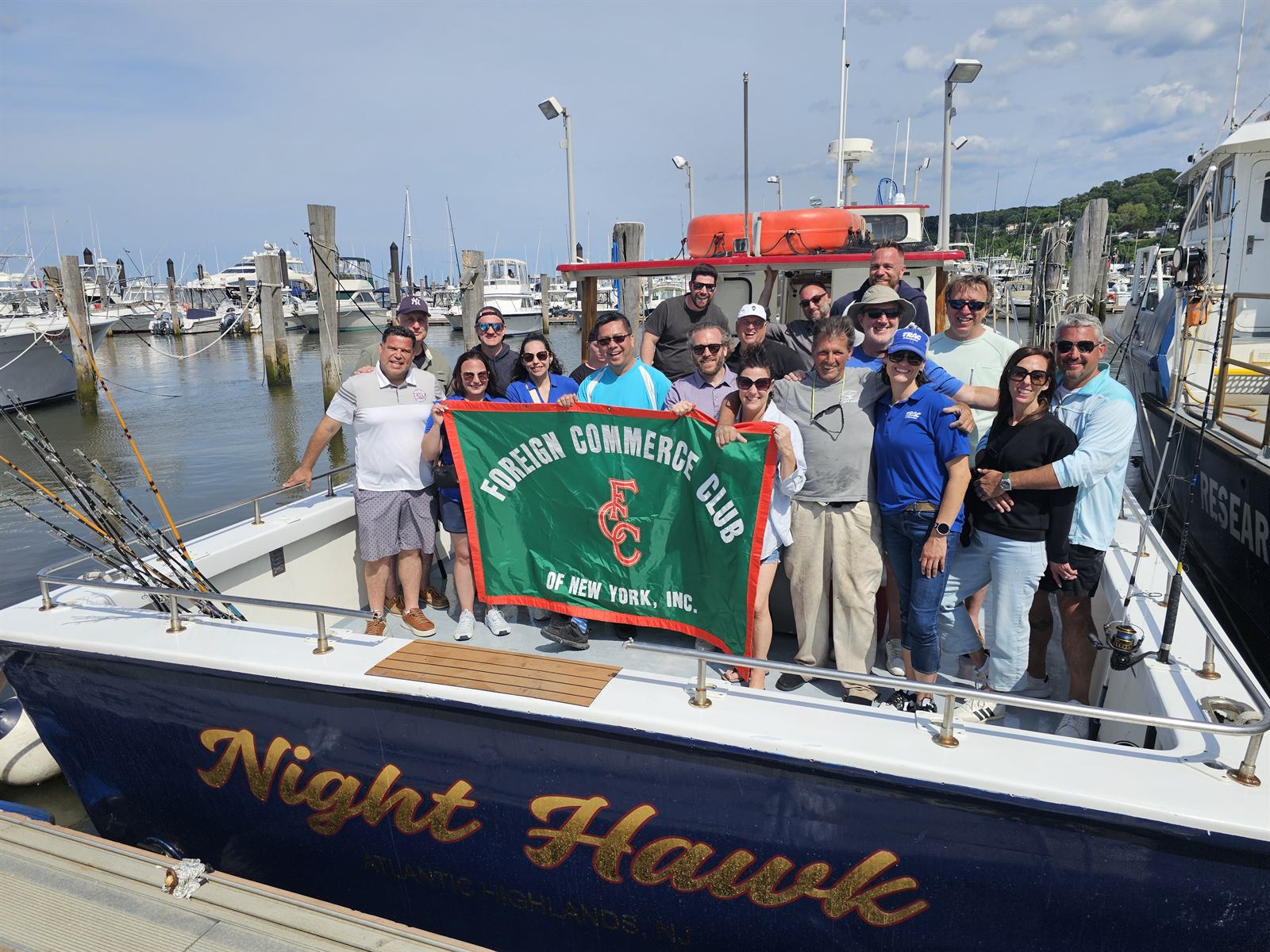 A large corporate group on the bow of the Nighthawk