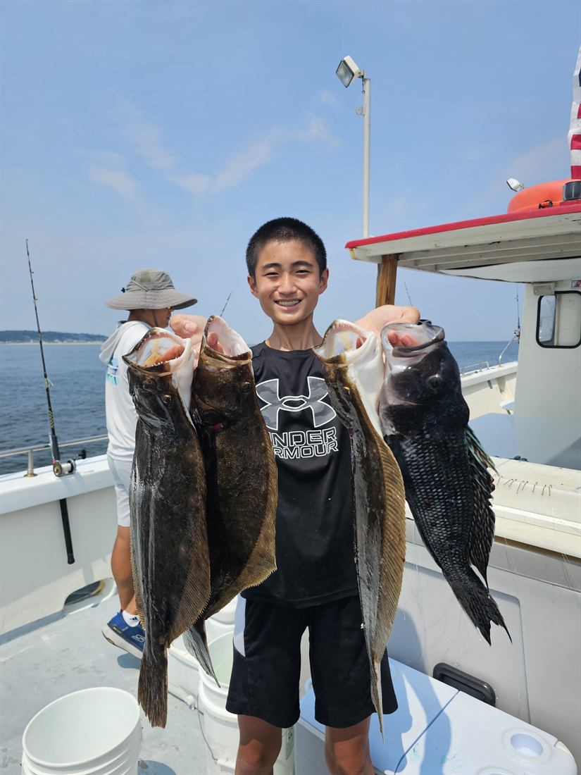 Young angler with black sea bass